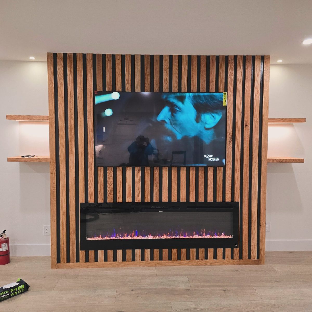Full home remodel by Grant Langston Customs featuring a custom wood-slat media wall with built-in fireplace